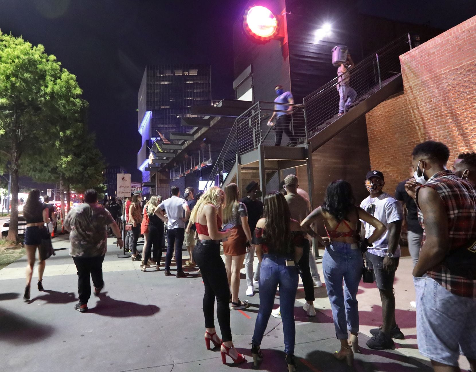 People gather outside Bottled Blonde in the Deep Ellum area of Dallas, TX, on Aug. 28, 2020....
