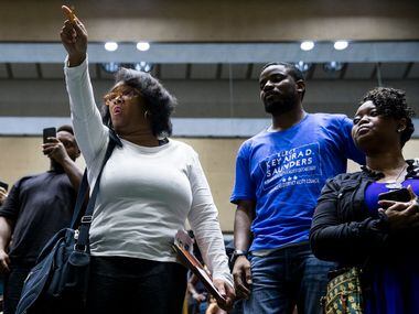 Olinka Green yells "No justice, no peace" after Mayor Mike Rawlings left the council...