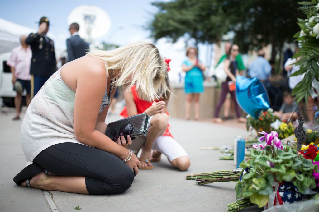 Christie Pressly, 35, of Jonesboro, Arkansas, prays in front of the memorial for the slain...