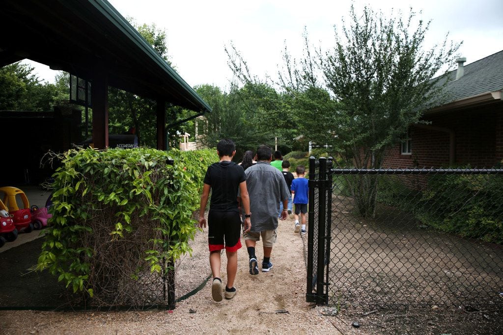 Boys from the emergency shelter walk through the courtyard at Jonathan's Place. 