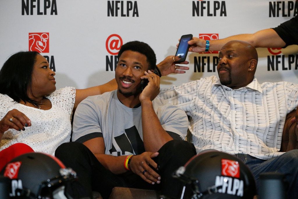 Myles Garrett of Texas A&M and Arlington Martin takes a phone call between his mother Audrey and Lawrence Garrett before he is announced the number one draft in the NFL by the Cleveland Browns at Terre Verde Golf Course in Arlington, Texas on April 27, 2017. (Nathan Hunsinger/The Dallas Morning News)