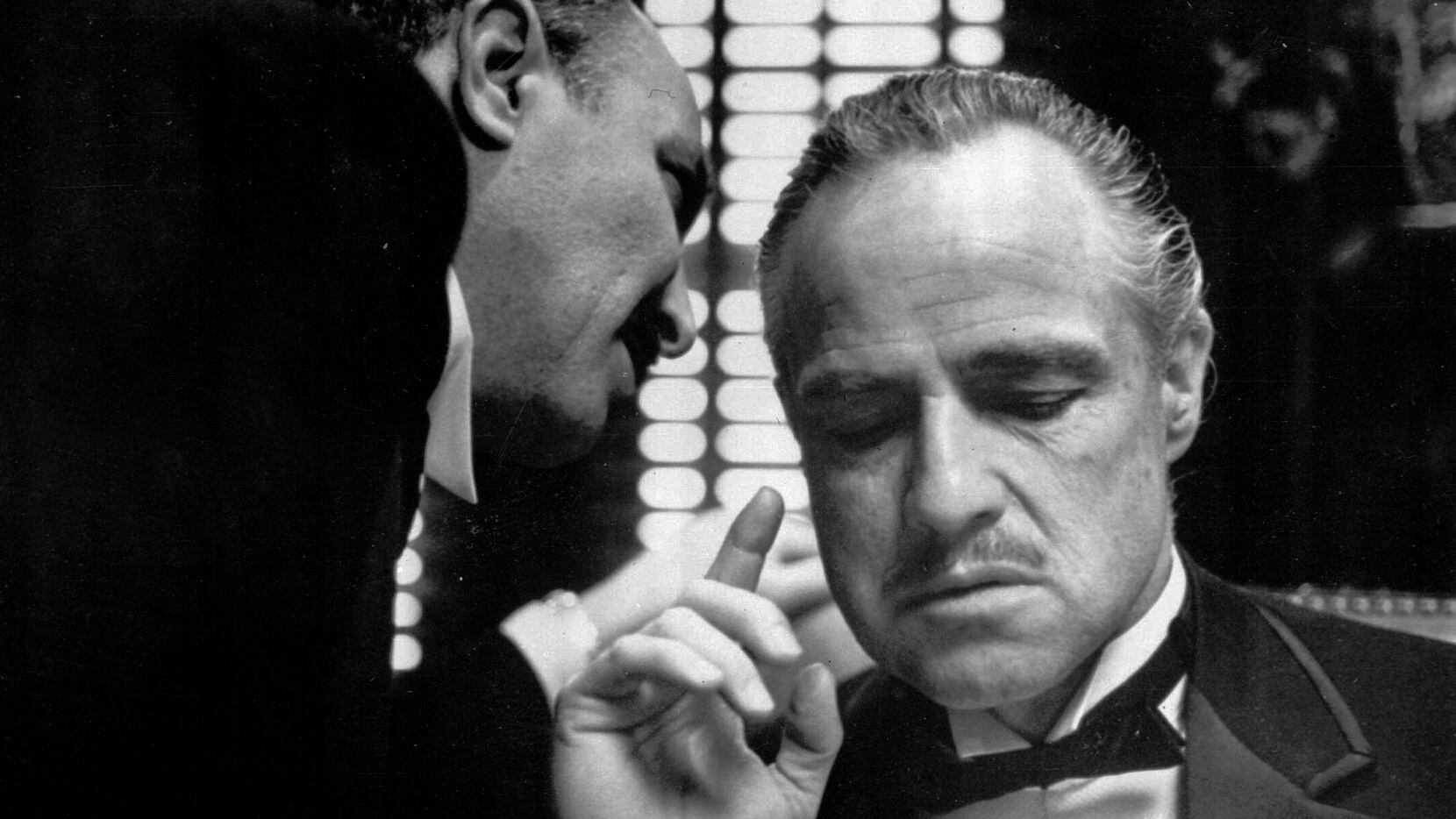 This photo provided by Paramount Pictures shows Marlon Brando, right, as Don Corleone, in a...