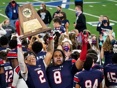 Denton Ryan wide receiver Billy Bowman Jr. (2) hoists the championship trophy with teammate...