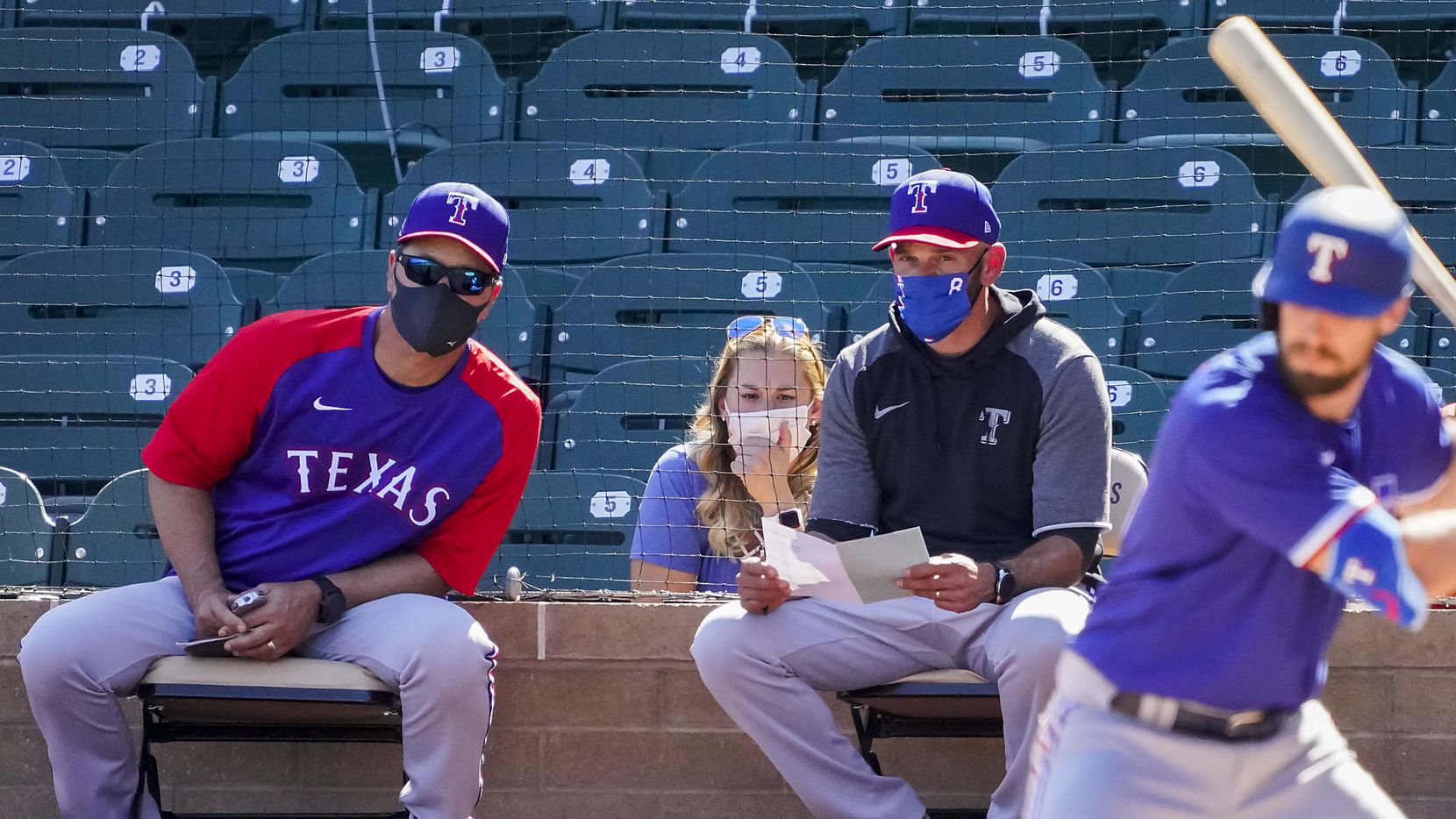 Texas Rangers manager Chris Woodward (right) and bench coach Don Wakamatsu watch designated hitter David Dahl bat during the fourth inning of a spring training game against the Arizona Diamondbacks at Salt River Fields at Talking Stick on Saturday, March 6, 2021, in Scottsdale, Ariz. 