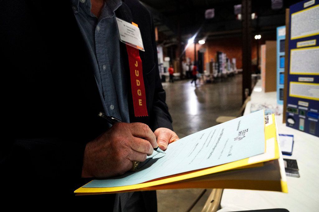 A judge scored an entry at the Dallas Regional Science and Engineering Fair last year in...