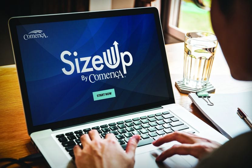 Person working on a laptop with SizeUp by Comerica displayed on the screen.