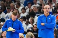 Dallas Mavericks head coach Jason Kidd (right) watches from the bench with assistant coach...