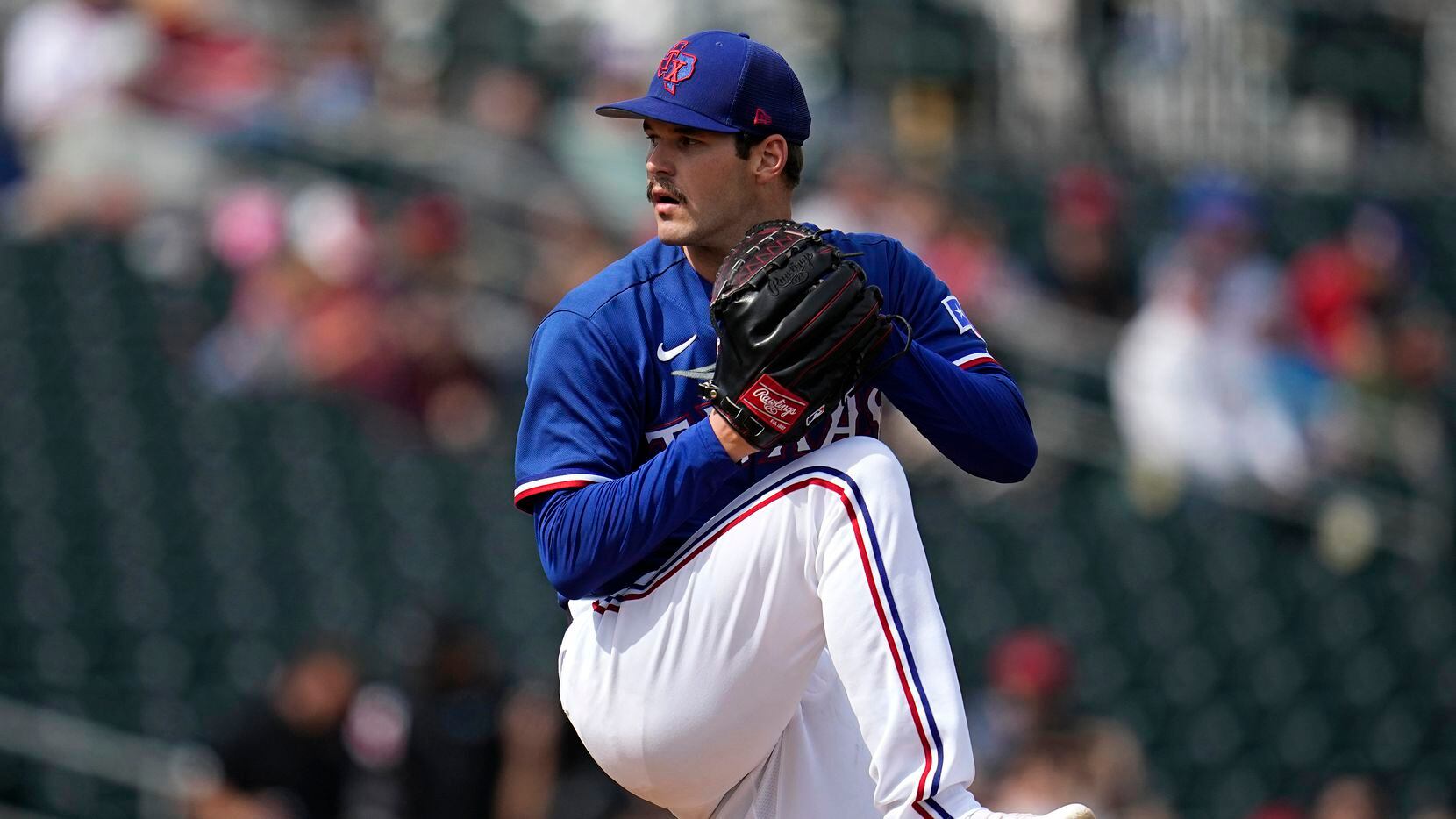 Texas Rangers starting pitcher Cole Ragans delivers during the second inning of a spring...