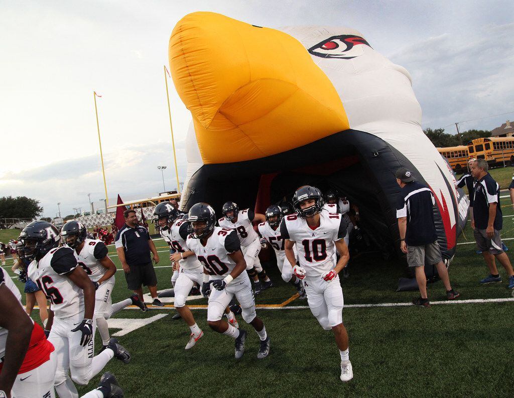 The Allen Eagles football team takes the field before kickoff as Plano High School hosted...