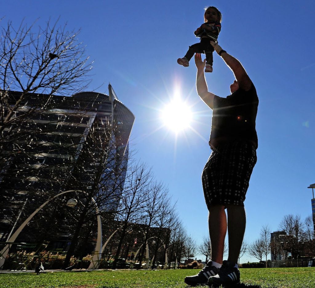 Eric Allen of Houston enjoys the sun-drenched afternoon with his 19-month-old daughter Addison at Klyde Warren Park in downtown Dallas, photographed on Monday, January 23, 2017.