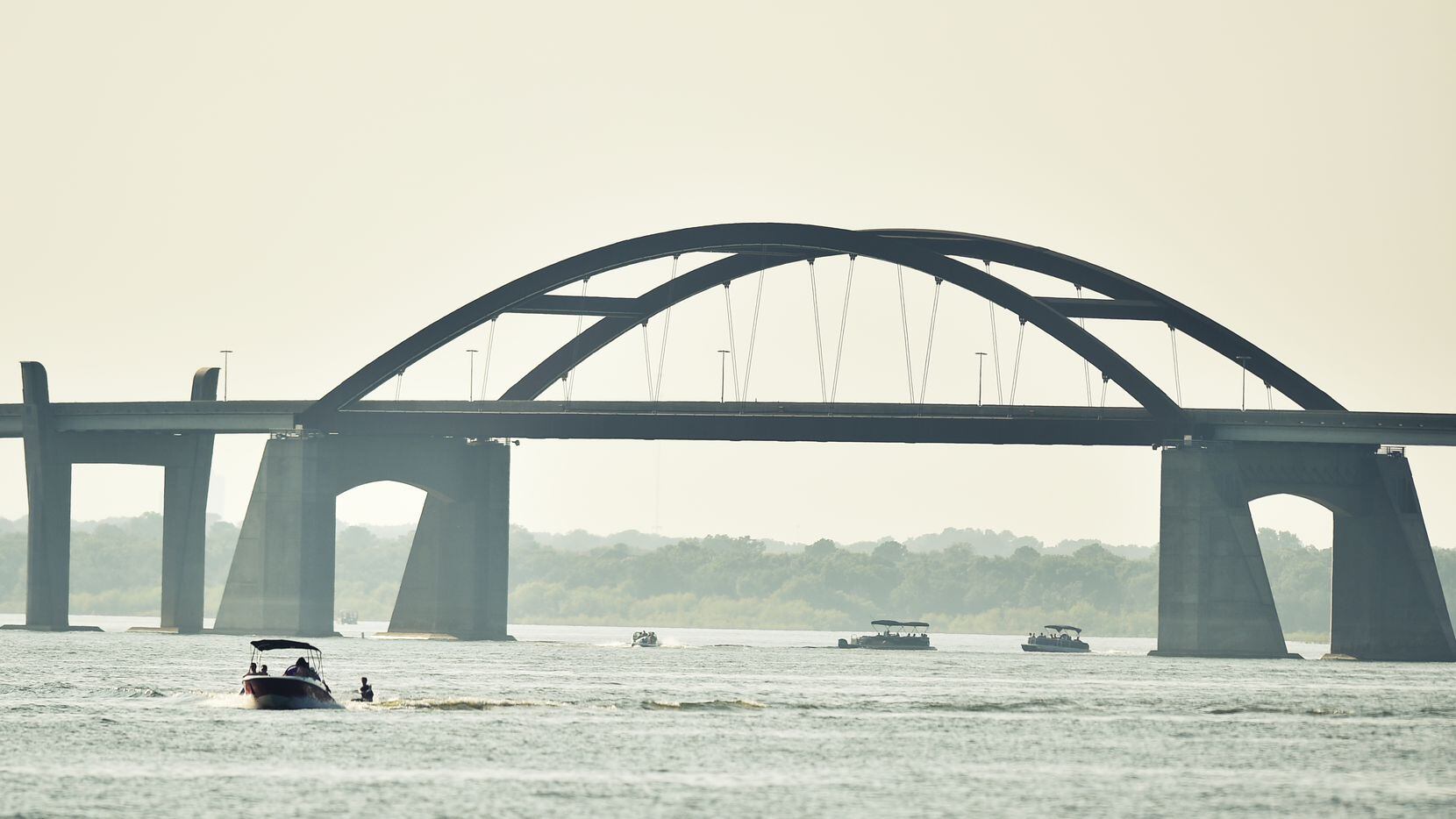 Boaters enjoy the sunny weather on Lewisville Lake near the Lewisville Lake toll bridge in...