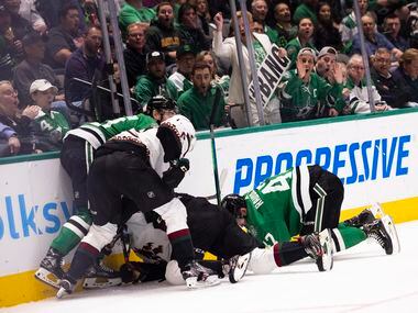 Fans react as the Dallas Stars and Arizona Coyotes fight for the puck during the first...