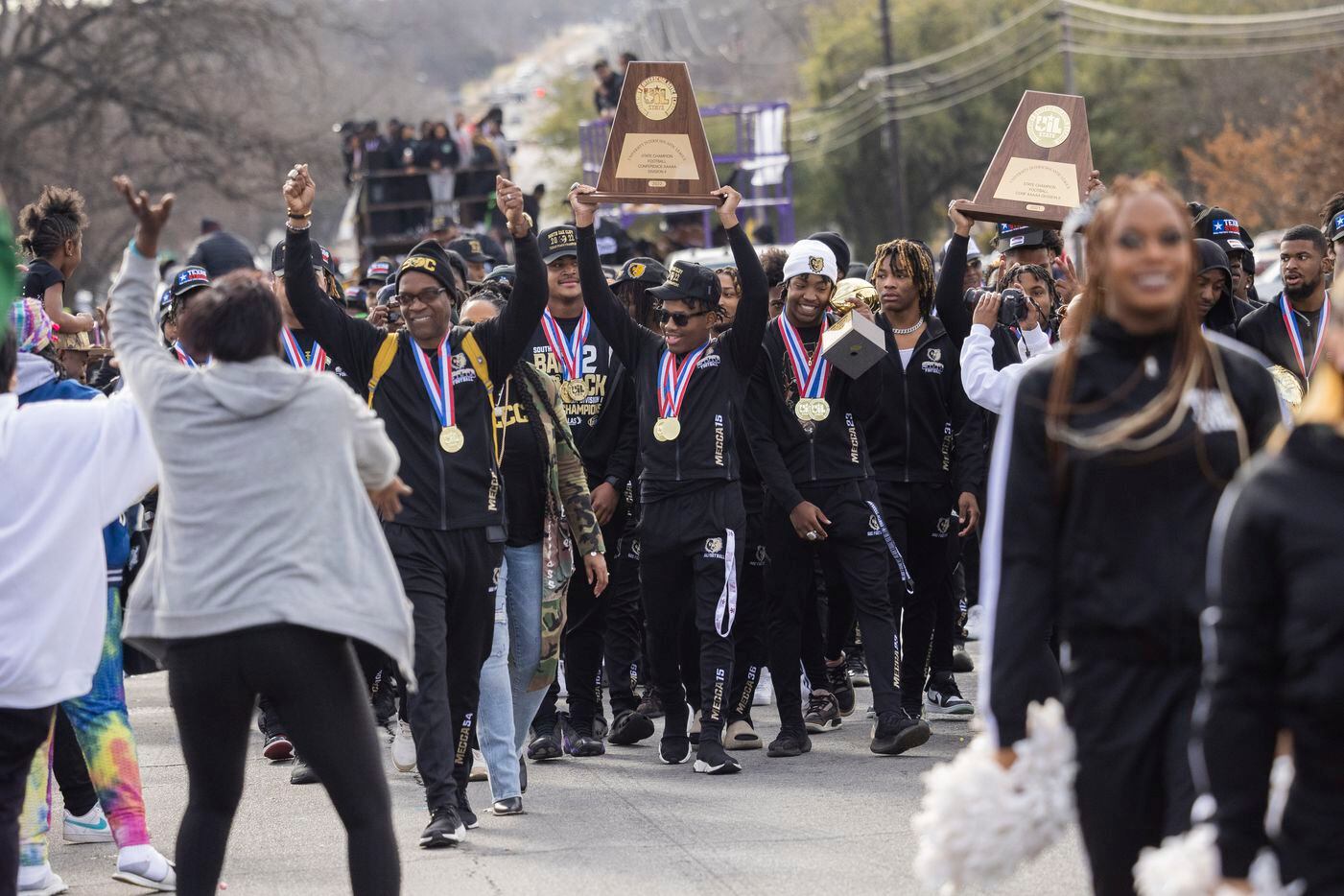 The South Oak Cliff Golden Bears march during a parade honoring their Division II 5A state.
