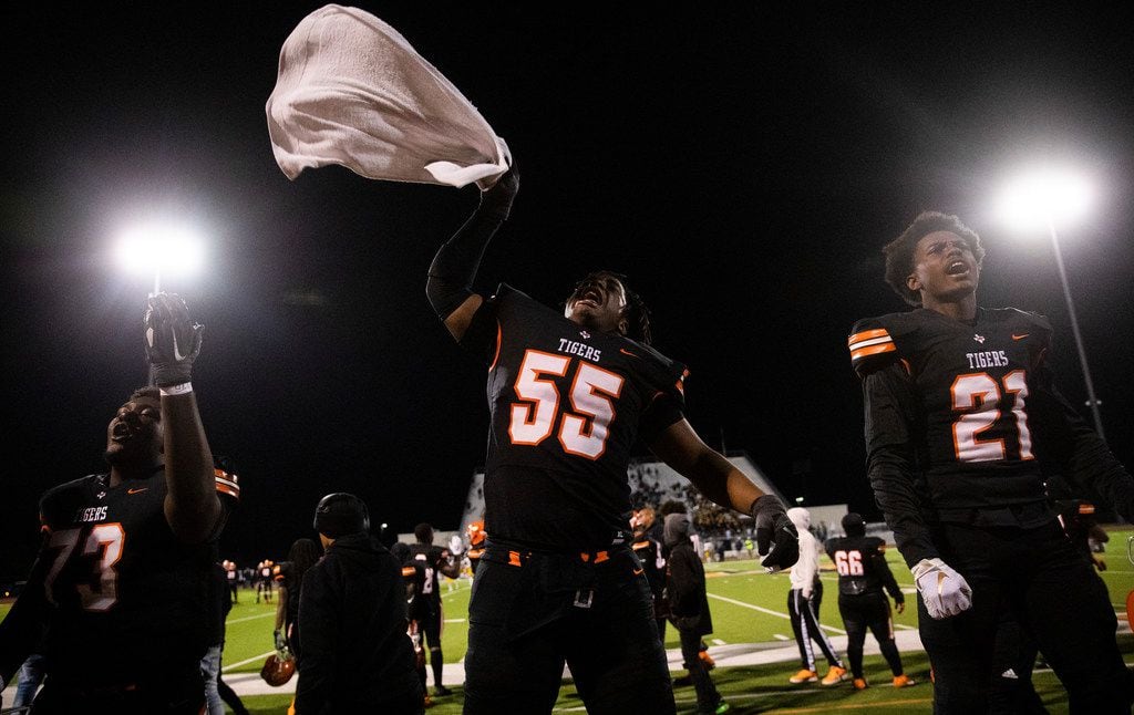 Lancaster offensive lineman Kaleb Washington (55) and other players try to hype up fans at...