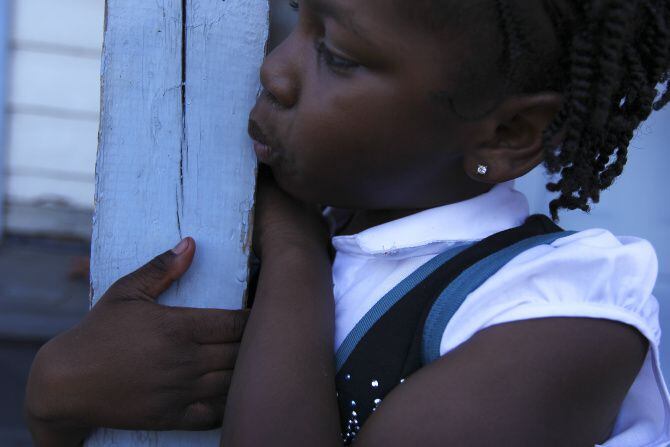 Derrionna "DeeDee" Shanks, 6, plays on the porch of the Liberty in Christ House of God...