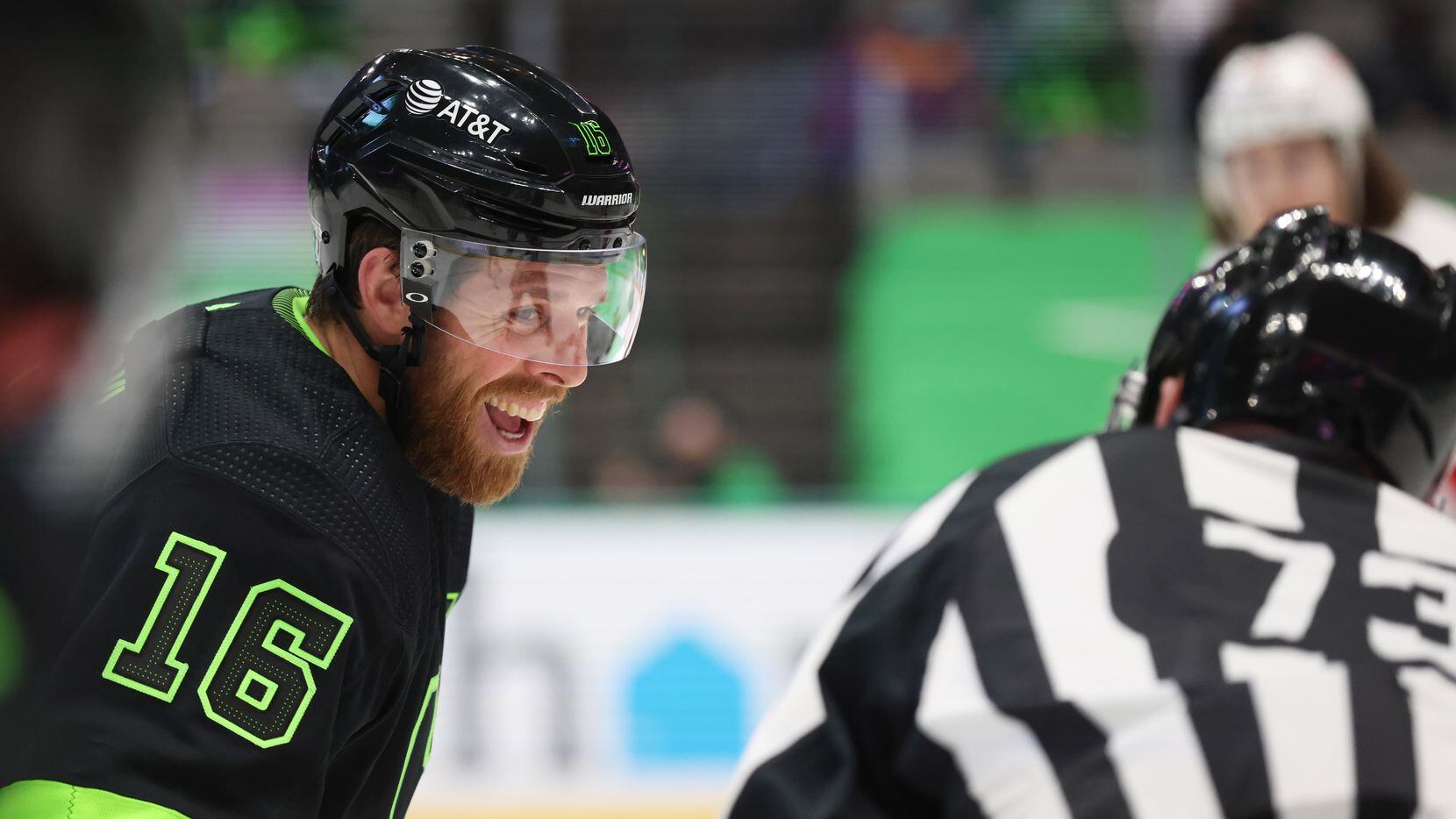 Dallas Stars center Joe Pavelski (16) laughs with linesman Vaughan Rody (73) before a...
