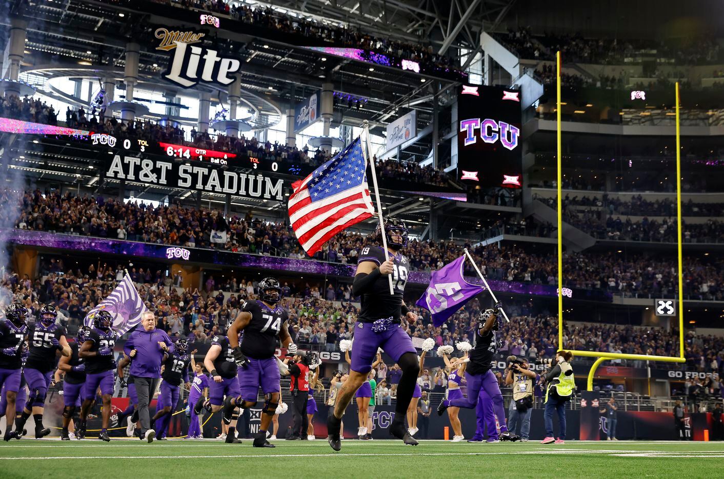 TCU Horned Frogs tight end Jared Wiley (19) carries the U.S.flag as he leads his team onto...