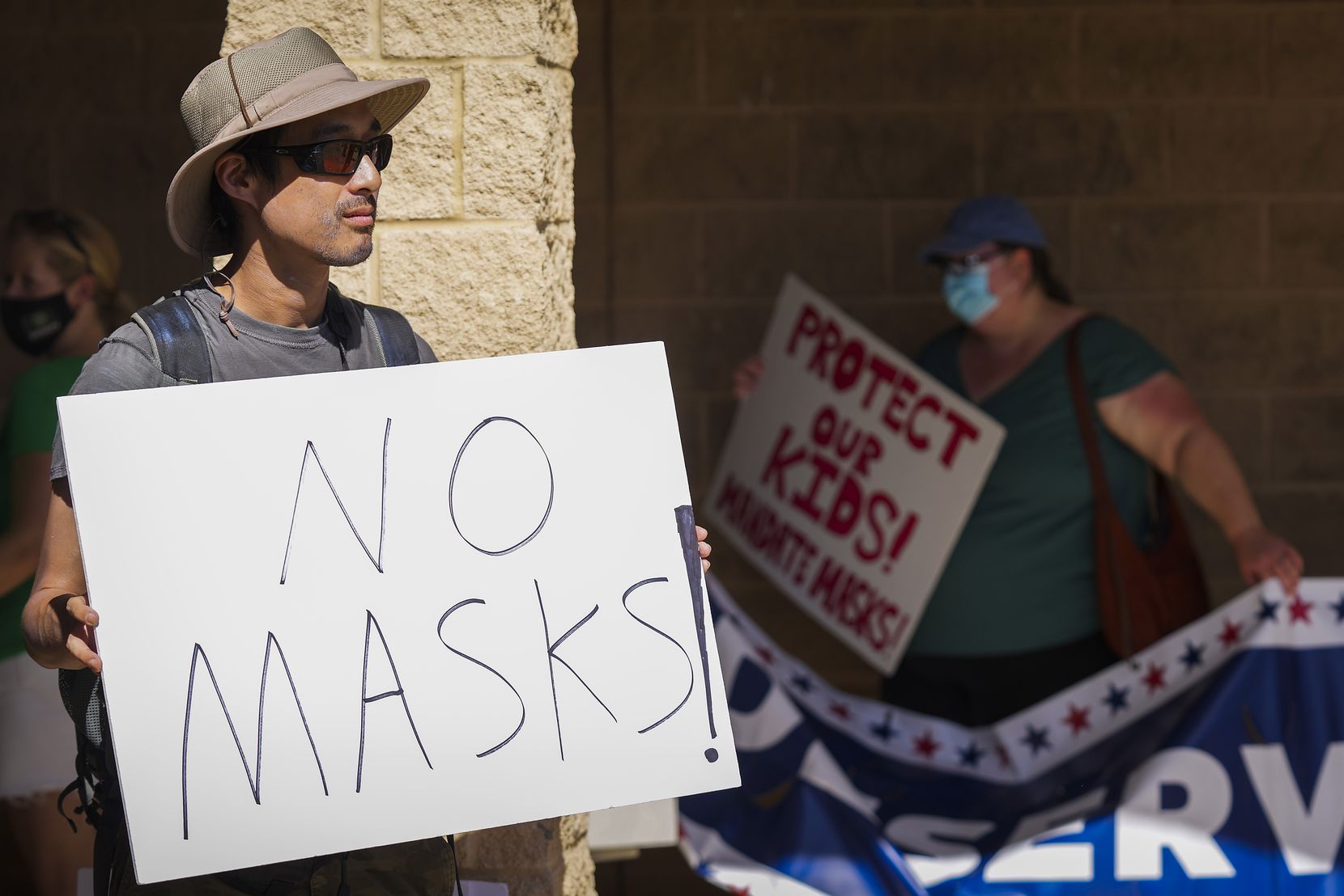 Opponents and supporters of mask mandates rallied outside before a Carroll ISD board meeting in August.