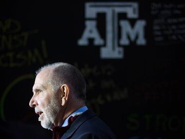 Michael K. Young, president of Texas A&M University, speaks to reporters before the Aggies...