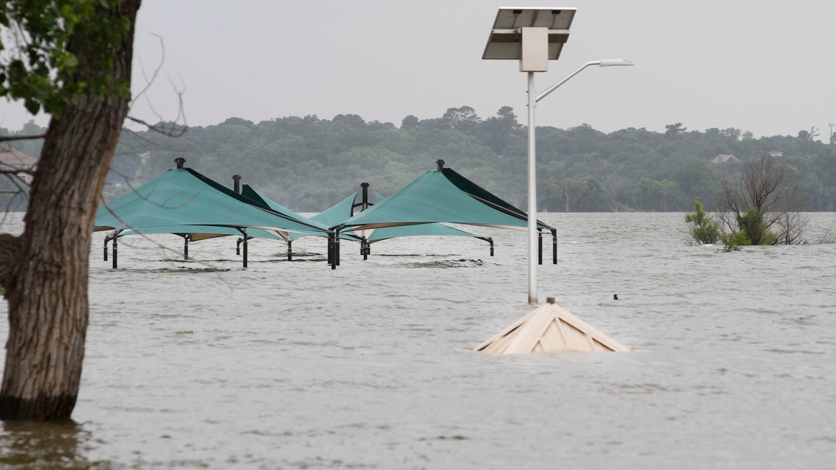 Tops of pavilions sticking out of high water at a closed Murrell Park on the north shore of...