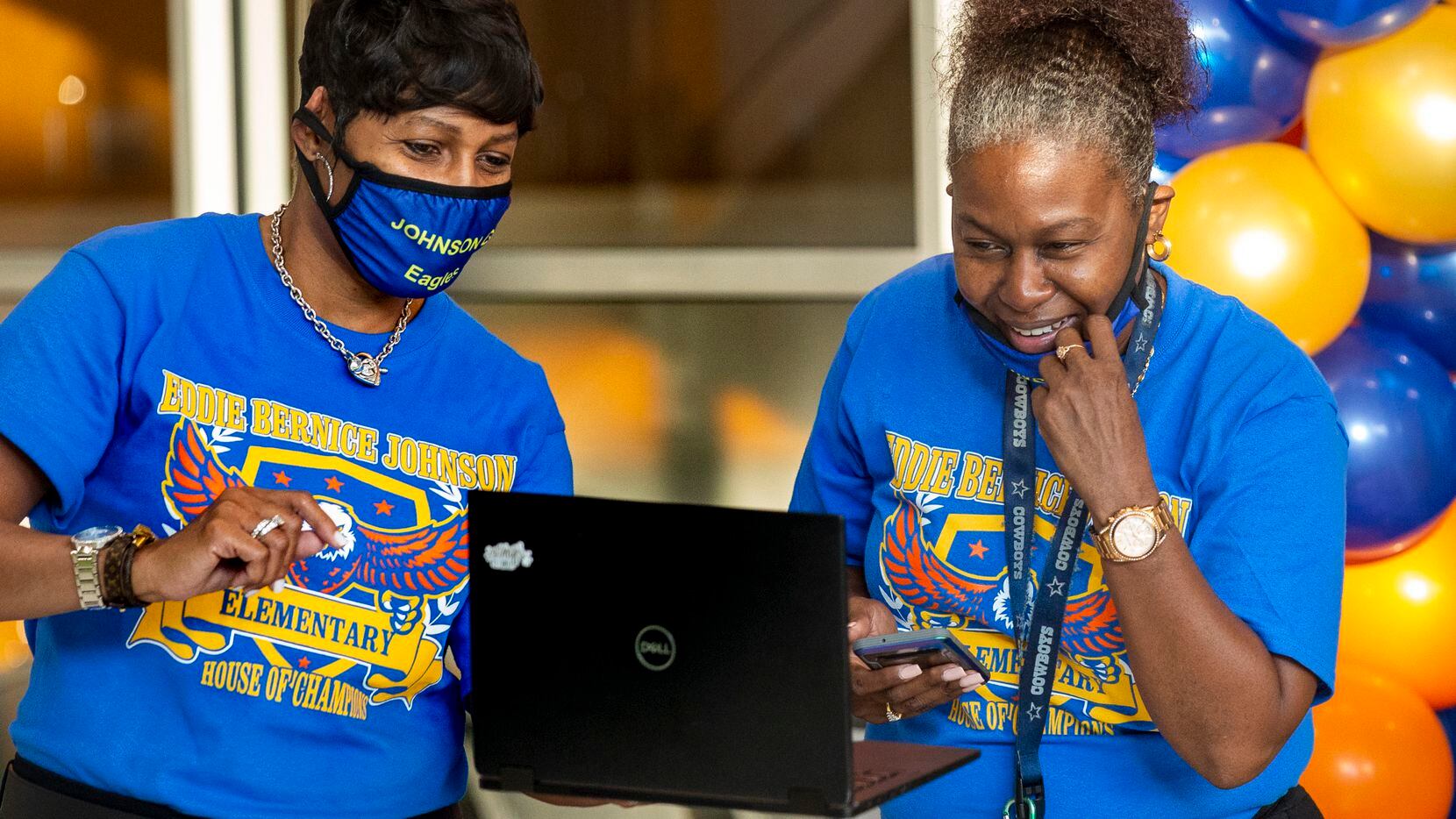 Teacher Melanie Nash, left, carries a computer to virtually introduce her students to their...