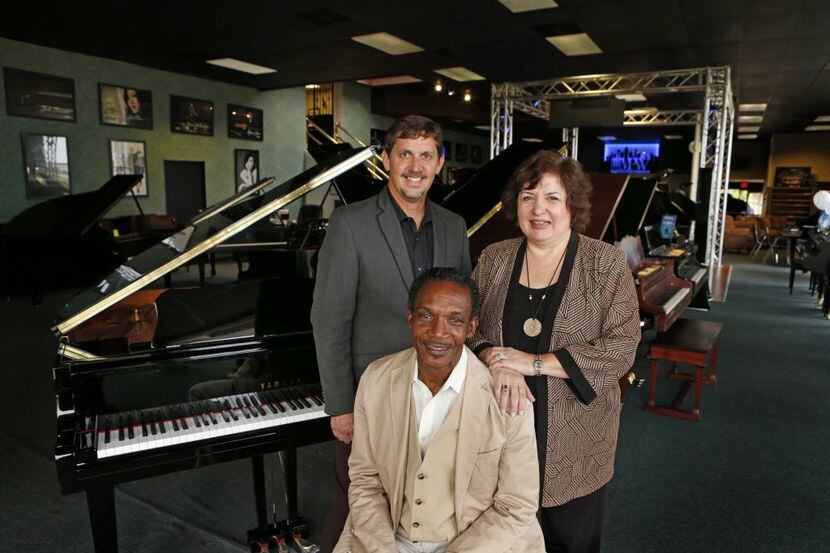 Johnnie Lindsey (seated), at Metroplex Piano with owner Darren Speir and Debbie Beach,...