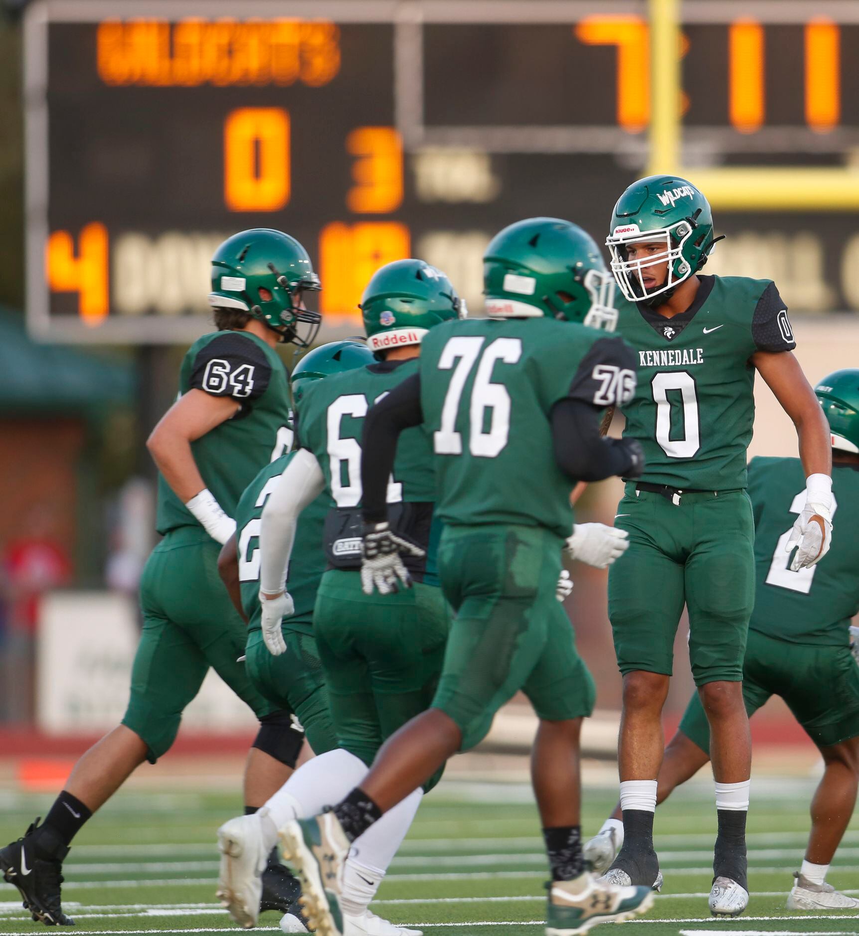 Kennedale defensive back Braden Waters (0), right, leaves the field after making a defensive...