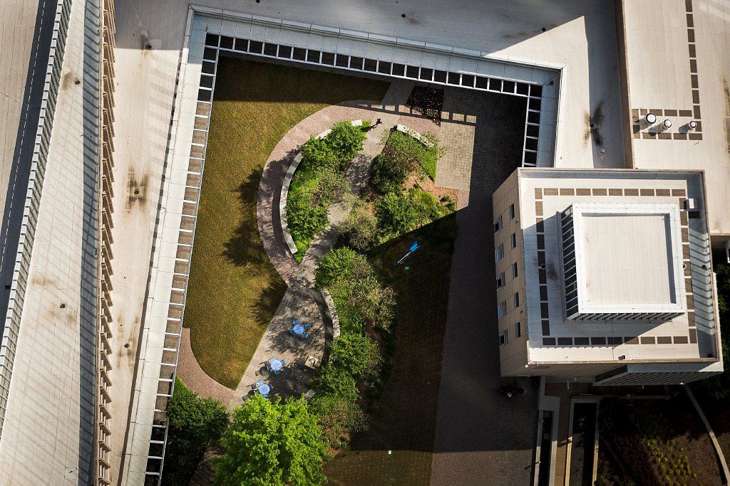Landscaping and a sidewalk of the rooftop garden at the Federal Reserve Bank of Dallas form...