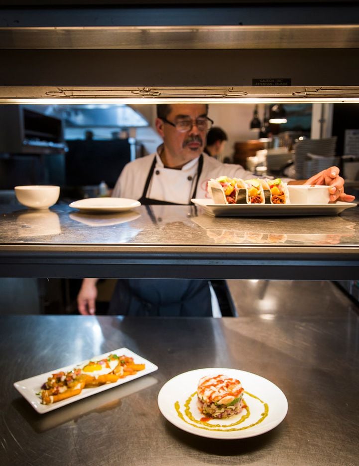 Chef Beto Rodarte puts the finishing touches on a plate ready awaiting pickup in the in the...