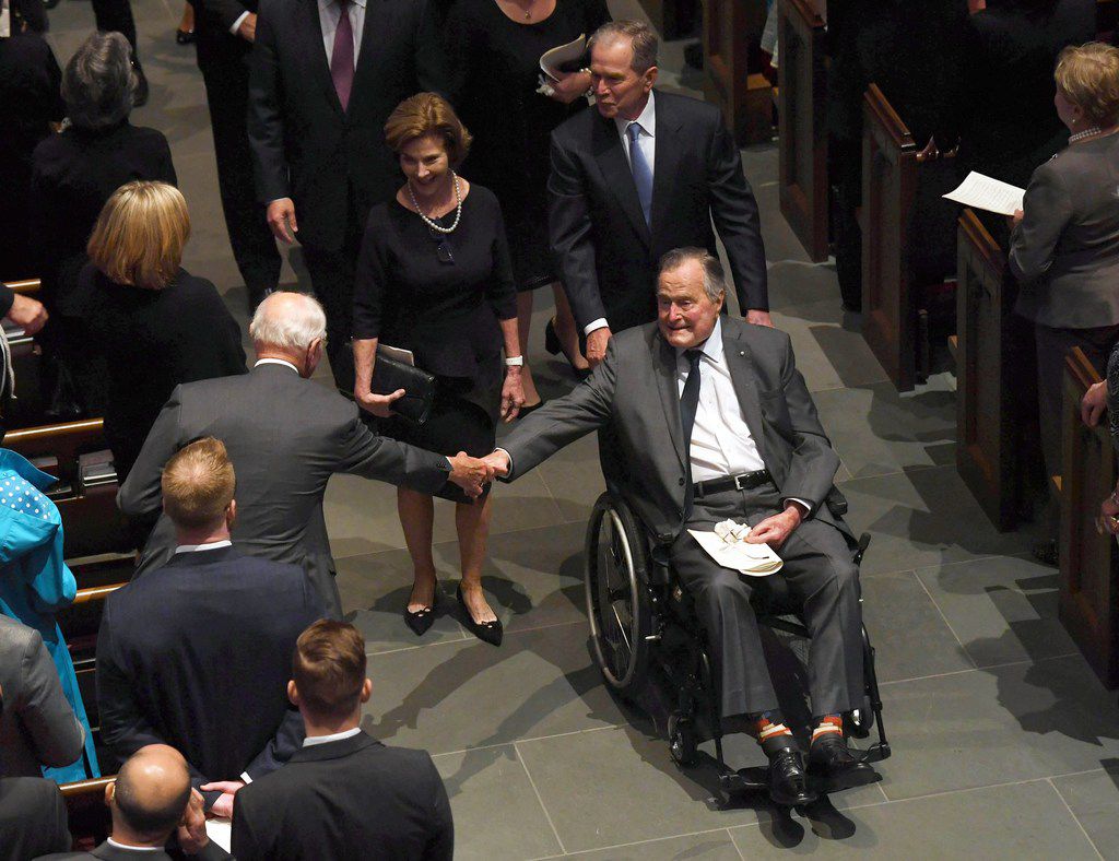 TOPSHOT - Former US President George H.W. Bush exits the funeral of his wife First Lady...