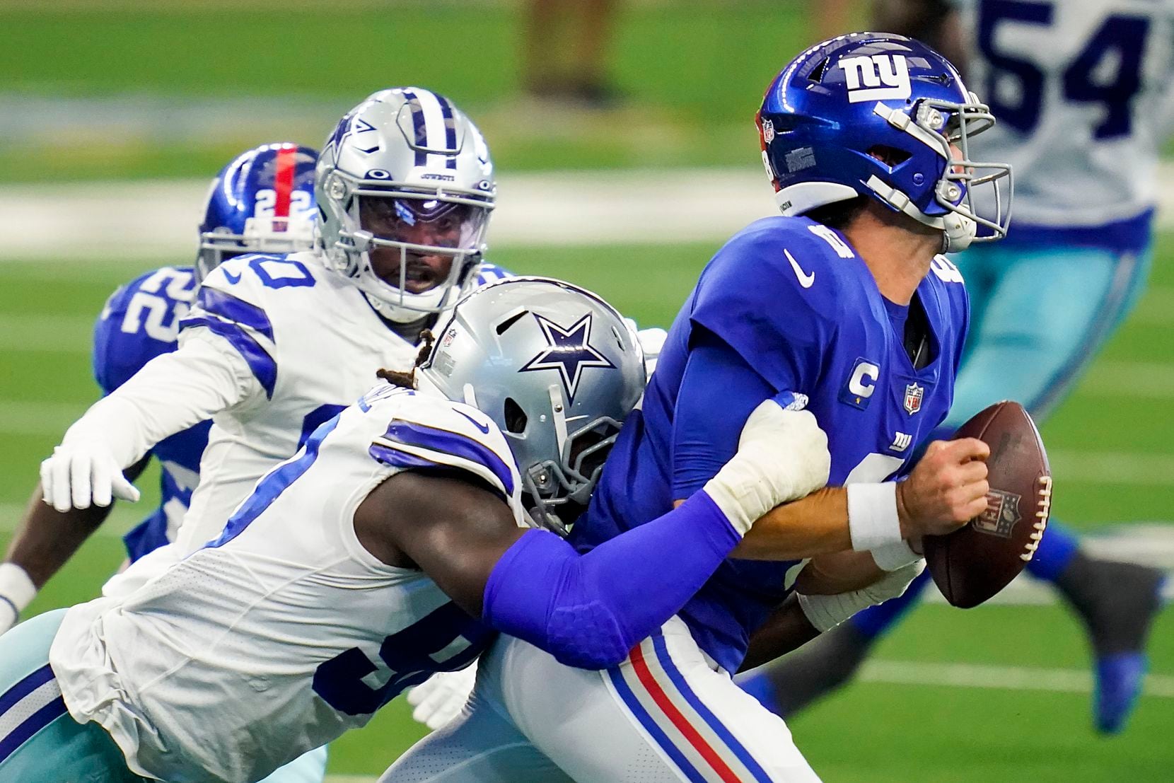 New York Giants quarterback Daniel Jones (8) fumbles as he is hit by Dallas Cowboys...