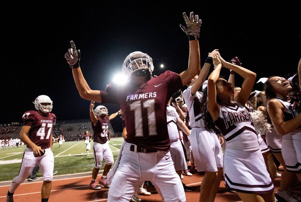 Lewisville senior Conner Jorgenson (11) celebrates his team's 41-16 victory over McKinney Boyd with cheerleaders and fans after a high school football game on Friday, September 13, 2019 at Max Goldsmith Stadium in Lewisville. (Jeffrey McWhorter/Special Contributor)