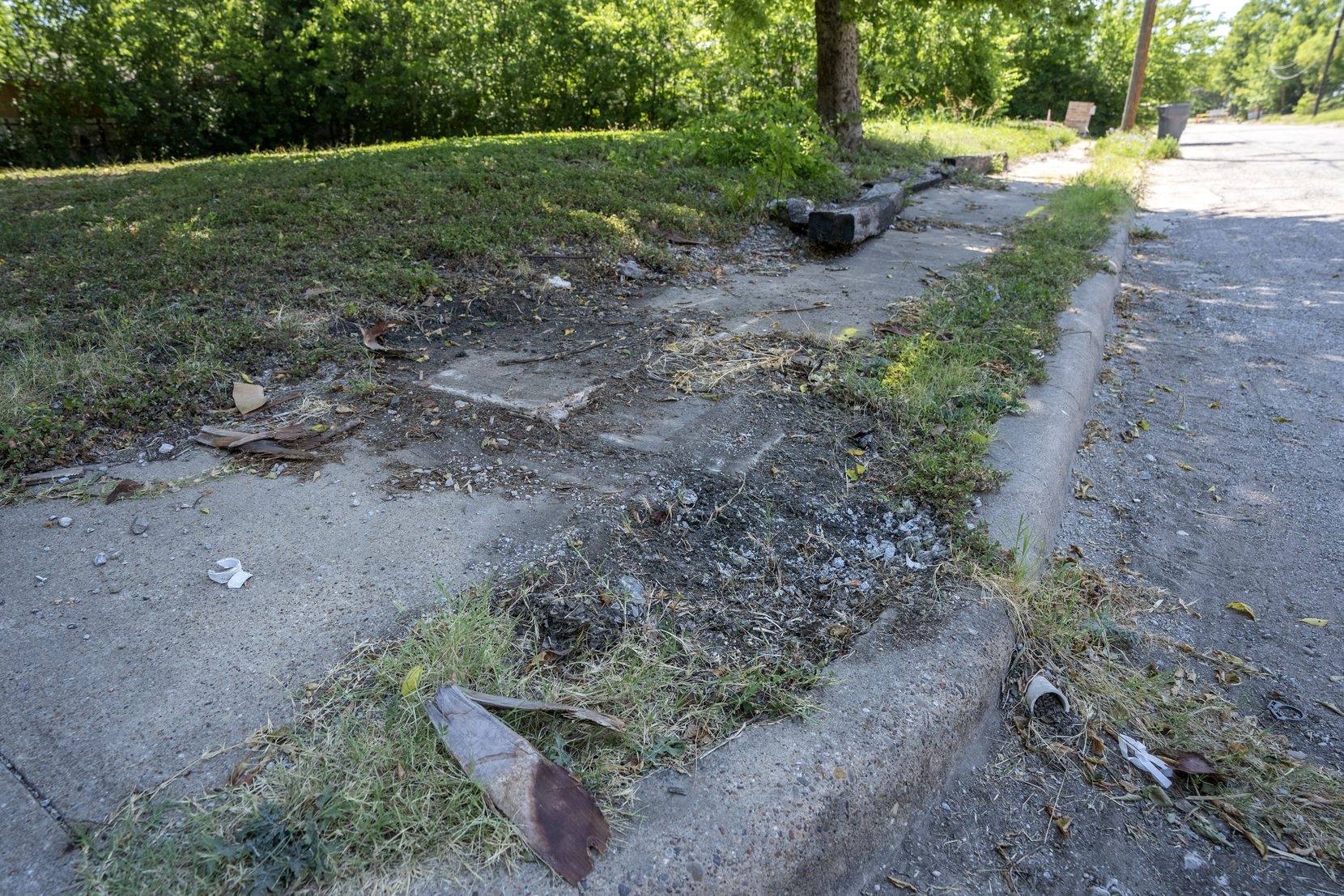Debris lies on a crumbled sidewalk on Fleetwood Street Wednesday, June 29, 2022 in the...