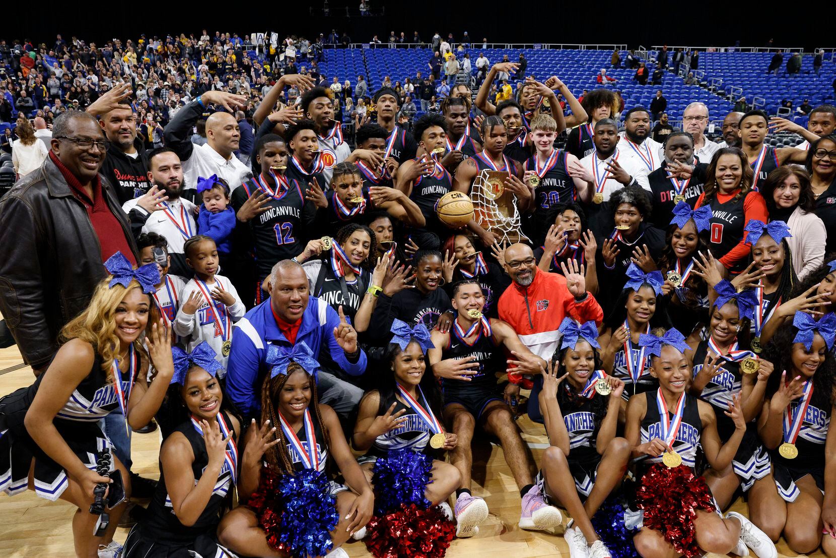 Duncanville players, cheerleaders and staff pose for photos after winning the Class 6A state...