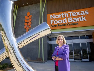 Trisha Cunningham, CEO and president of the North Texas Food Bank, stands next to a sculpture at the North Texas Food Bank Perot Family Campus in Plano. The piece is called Lulu May’s Mark and is a tribute to the mother of the late Ross Perot Sr. and his sister, Bette Perot.