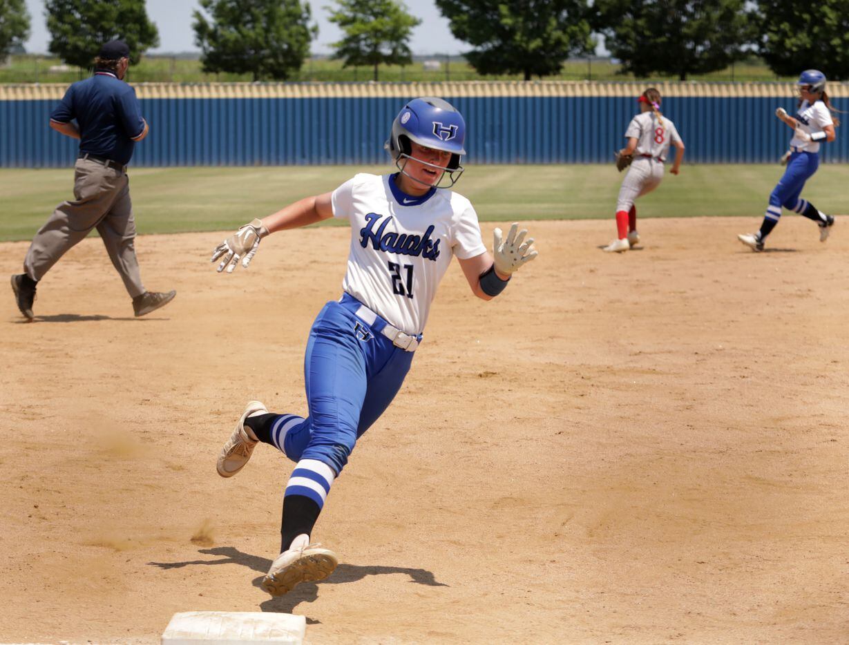 Hebron High School player #21, Allie Lovett, races to round third base during a softball...