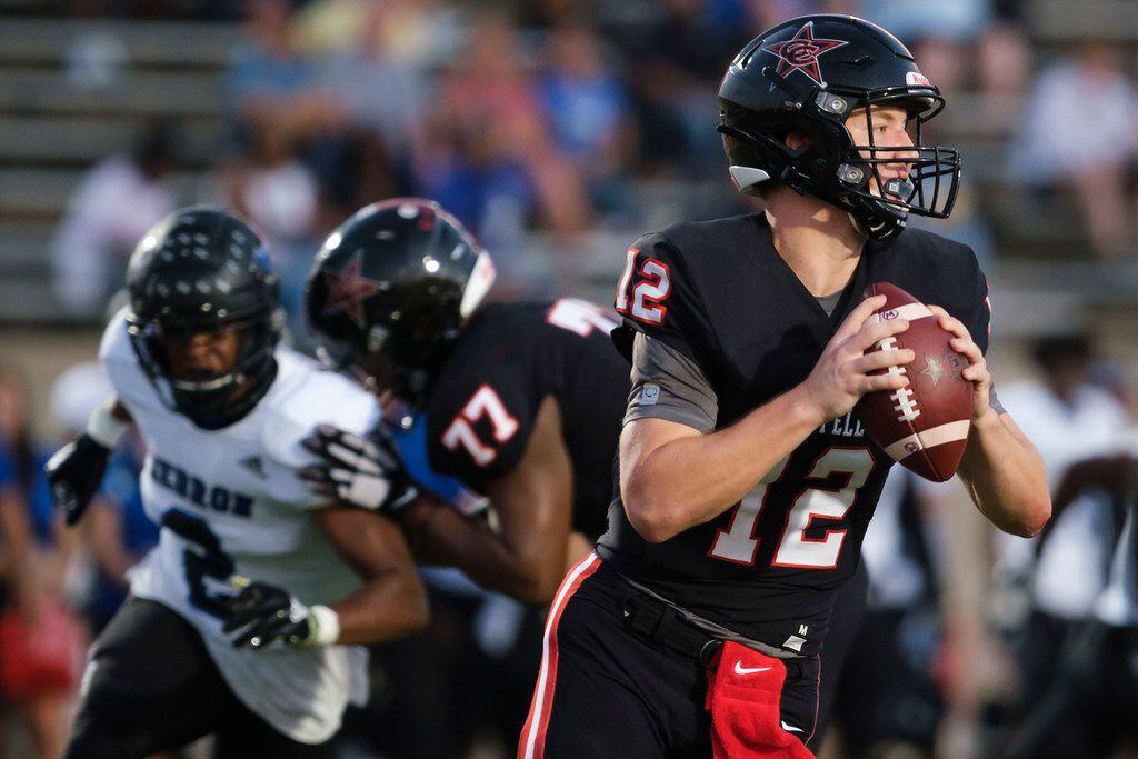 Coppell quarterback  Kevin Shuman scrambles away from the Hebron rush during the first half...
