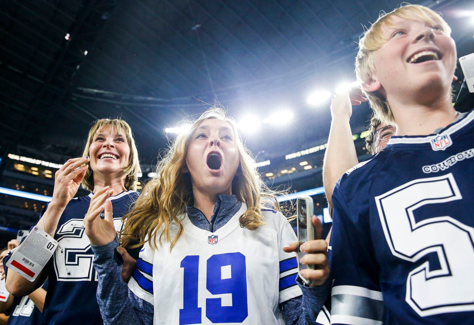Cowboys fans react from the sidelines as players head to the field to warm up prior to an...