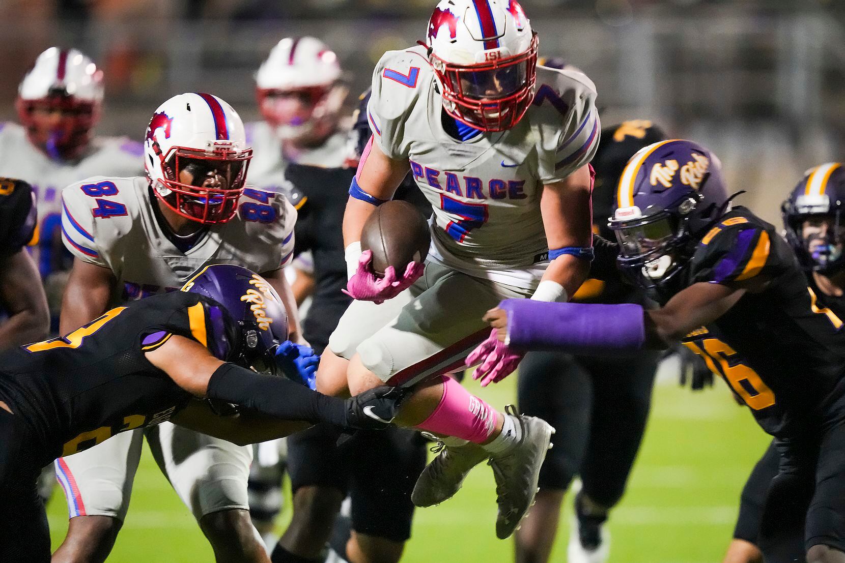 Richardson Pearce running back Christian Baker (7) tries to leaps past a pair of Richardson...