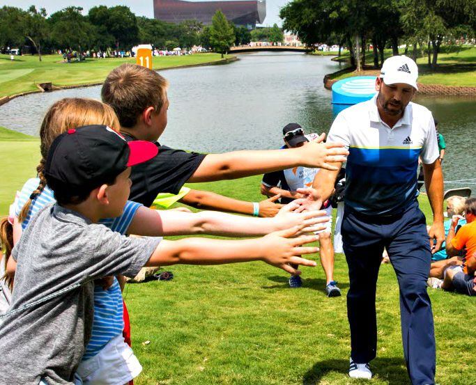 Youngsters reach out to high five Sergio Garcia during the final round of the 2016 AT&T...