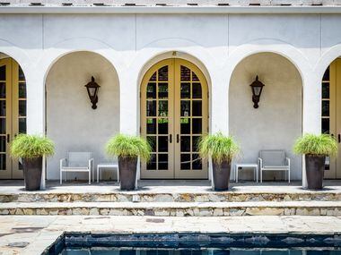 Three sets of French doors overlook the home's pool.