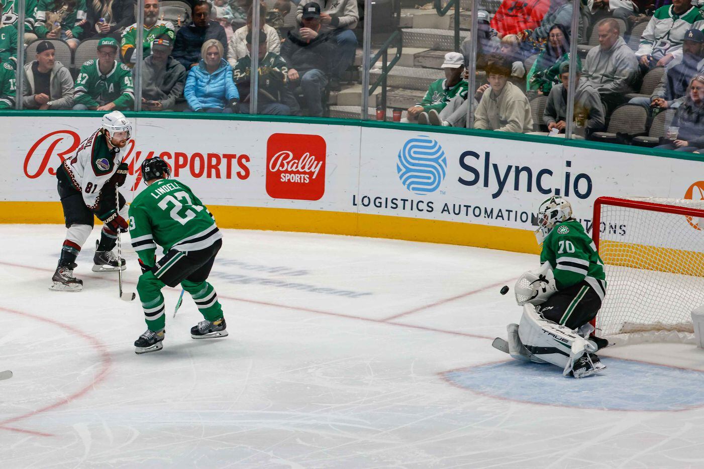 Dallas Stars goaltender Braden Holtby (70) stops a shot to the net by Arizona Coyotes right wing Phil Kessel (81) through Dallas Stars defenseman Esa Lindell (23) during third period at the American Airlines Center in Dallas on Monday, December 6, 2021. (Lola Gomez/The Dallas Morning News)