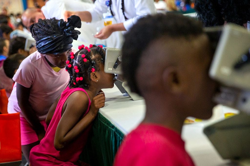 Samaria Jackson, 15 (left), skips into the 23rd annual Mayor's Back to School Fair at the...