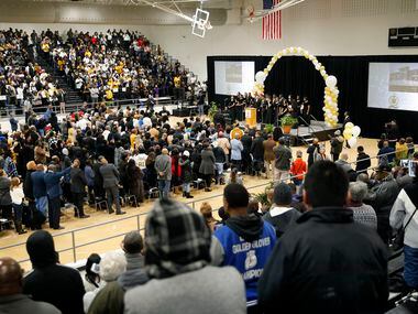 The South Oak Cliff High School choir performs 'Lift Ev'ry Voice and Sing' to those gathered...