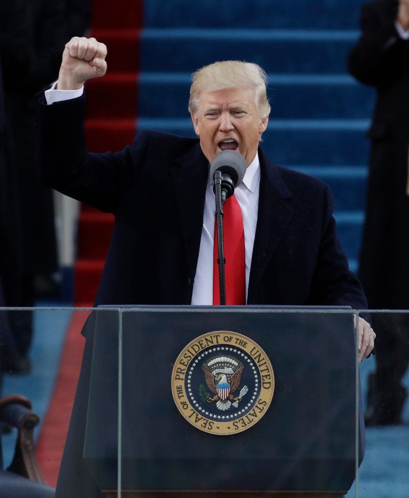 President Donald Trump pumps his fist after delivering his inaugural address after being...