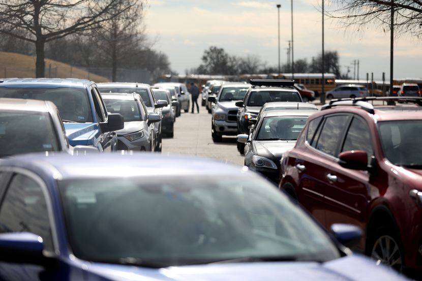 Lines of cars at at a COVID-19 testing center at Kuykendall stadium in Frisco, Texas,...