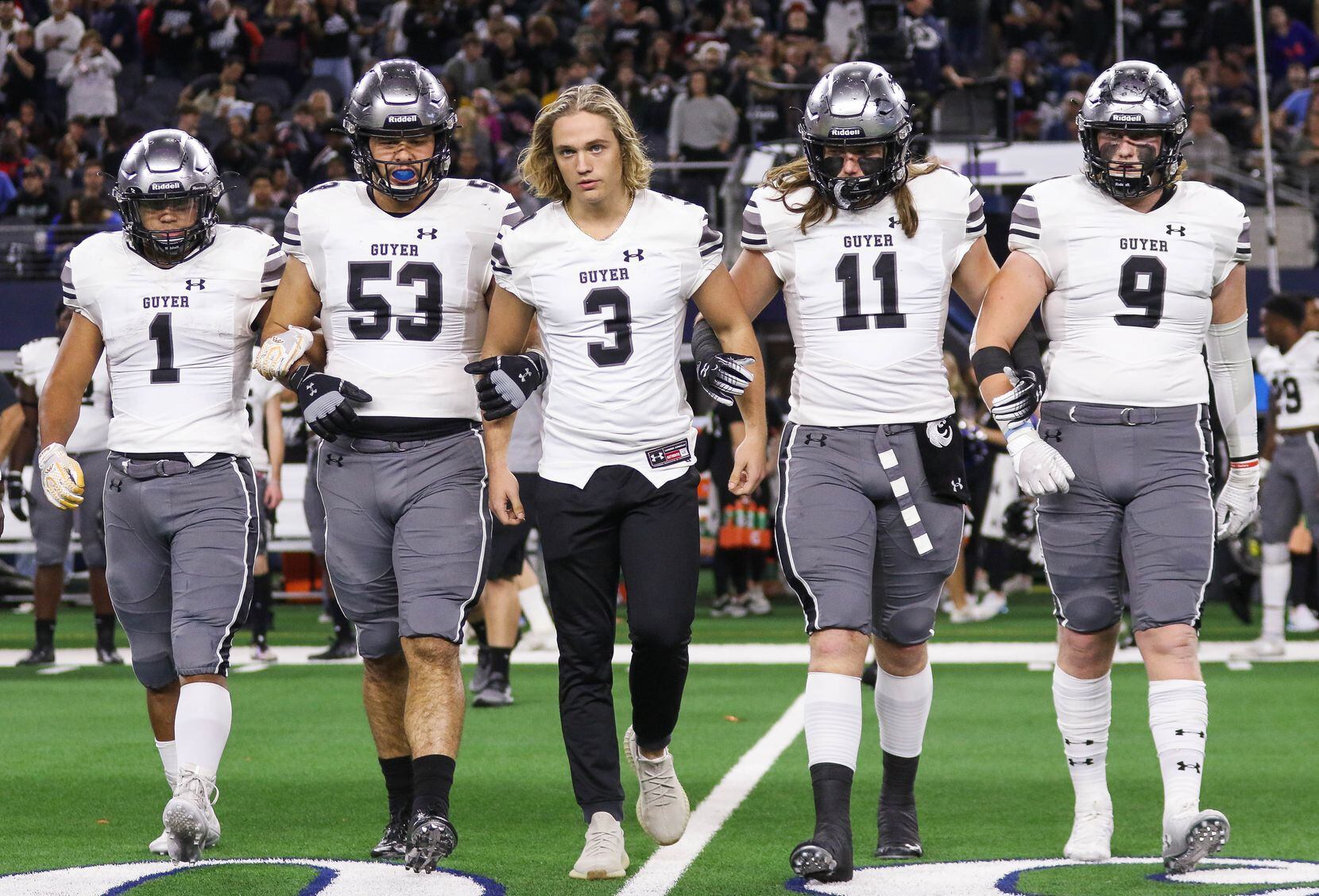 Denton Guyer walk to the coin toss of a Class 6A Division II state championship game against...