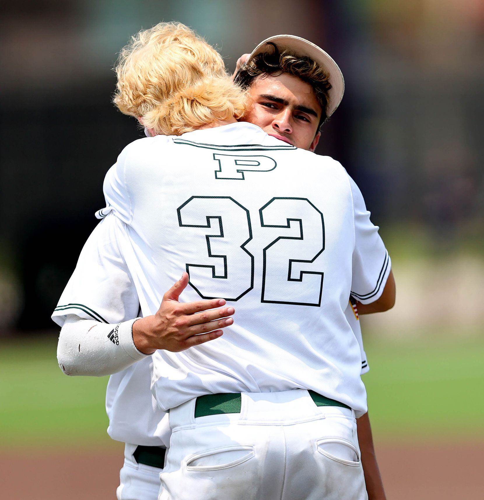 Prosper's Skyler Raley (32) and Austin Rogers hug after losing to Coppell, 3-2 in game 3 of...