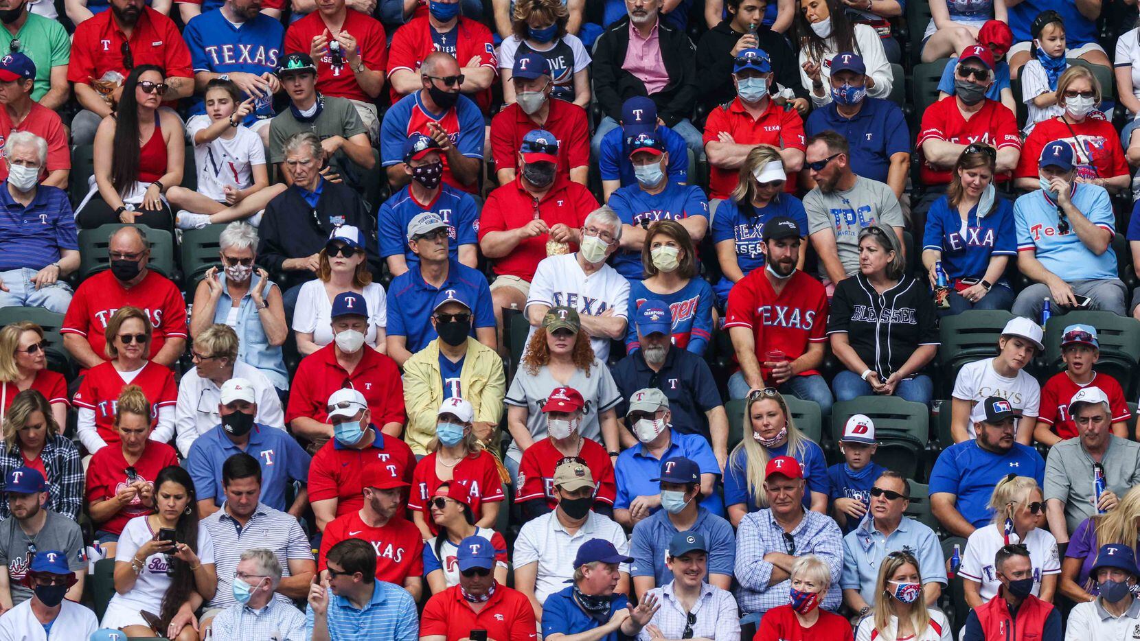 Fans watch the game between the Texas Rangers and the Toronto Blue Jays at the Globe Life...