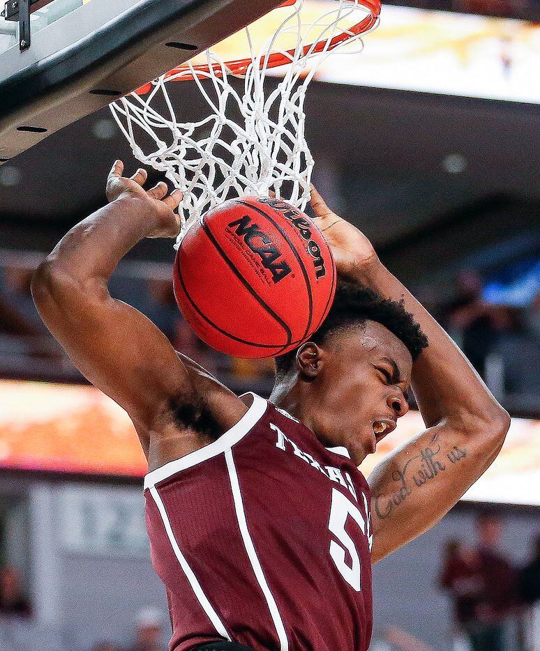 Texas A&M Aggies forward Emanuel Miller (5) scores during the second half of a basketball...